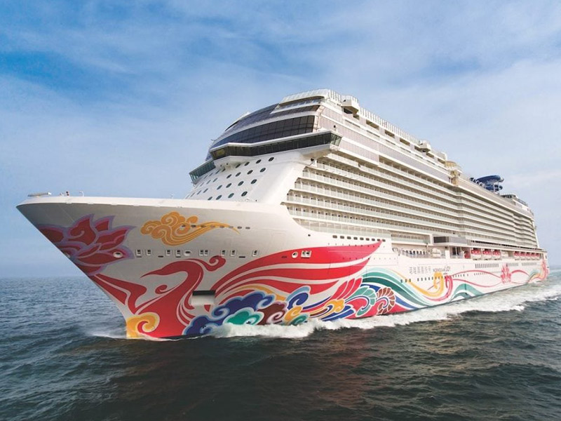 Norwegian ship with a brightly painted bow and hull out on the open seas
